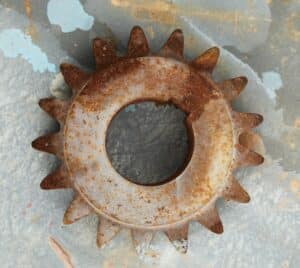 Rusty and corroded gear, showing visible damage from surface degradation