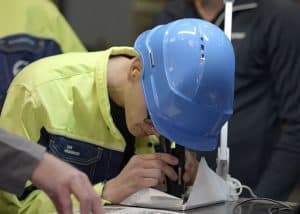 worker inspecting surface cleanliness with a magnifier